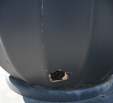 Details of a damaged fiberglass planter showing the thin wall of fiberglass