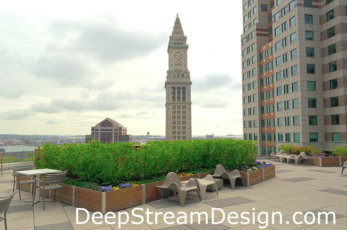 Lightweight modular custom wood planters make landscaping roof terraces possible as seen here atop a commercial building in Boston where they create outdoor dining and lounging spaces for tenants.